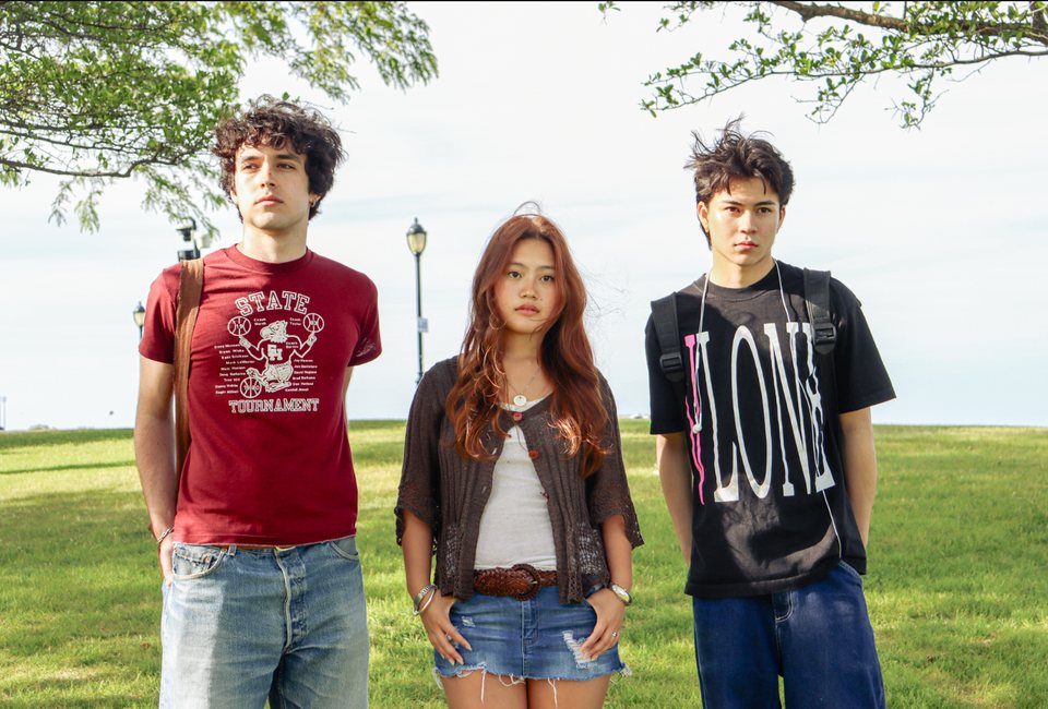 Three students on the lakefill in vintage tees and jeans